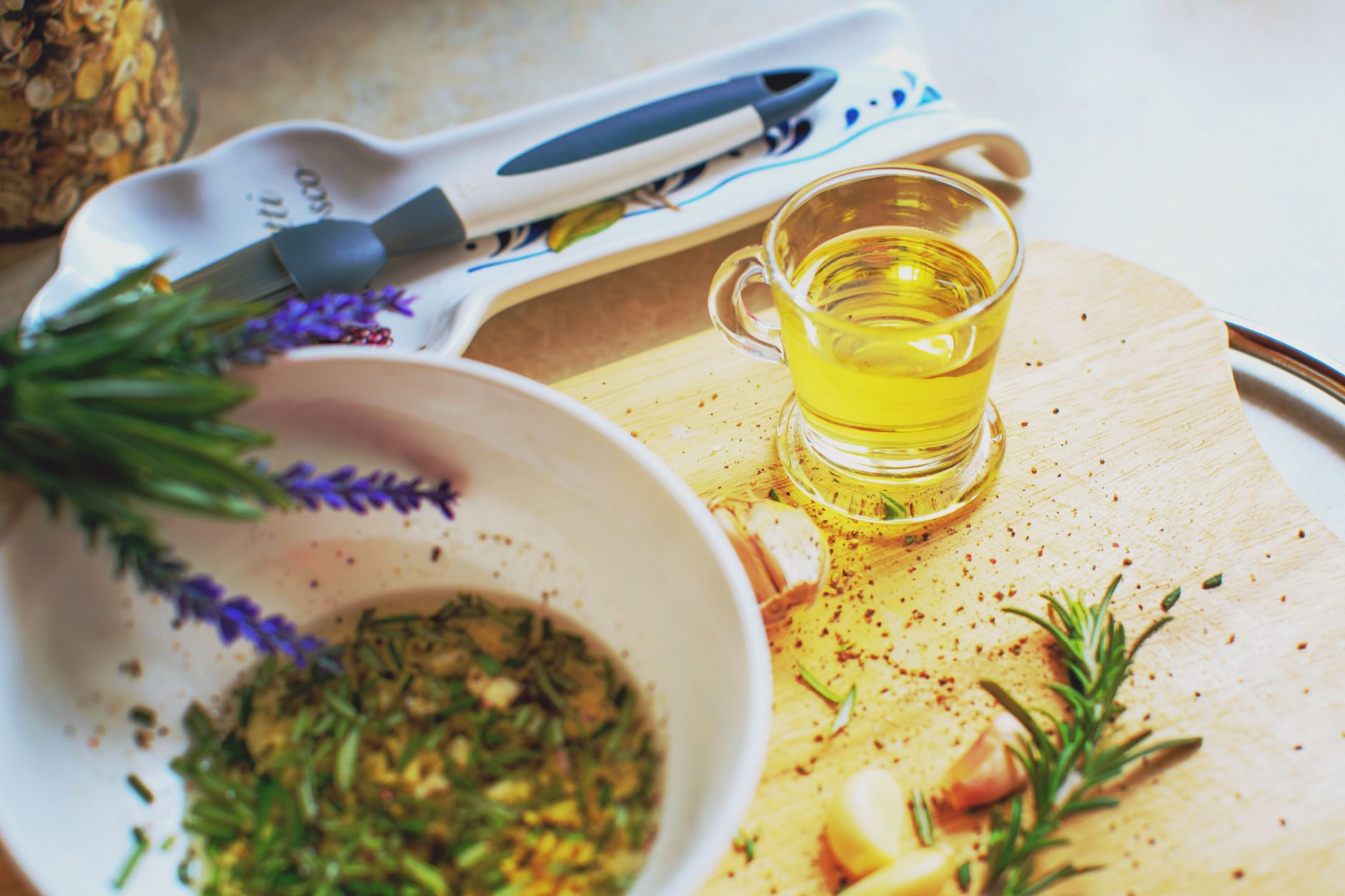 Wild herbs and cold pressed olive oil on stone table